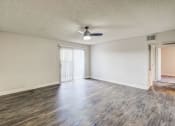 Thumbnail 13 of 48 - an empty living room with wood flooring and a ceiling fan at Denim Scottsdale, Arizona, 85251