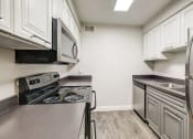 Thumbnail 6 of 48 - a kitchen with stainless steel appliances and white cabinets at Denim Scottsdale, Scottsdale, 85251