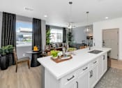 Thumbnail 1 of 54 - A modern kitchen with white cabinets and a large island.