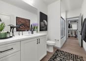 Thumbnail 12 of 54 - A bathroom with a white toilet and a sink.