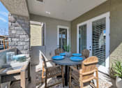 Thumbnail 13 of 54 - A patio with a table and chairs.