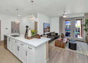 Thumbnail 15 of 54 - A modern kitchen with white cabinets and a large island.