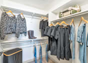 Thumbnail 24 of 54 - Clothes hanging on a rack in a room.