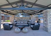 Thumbnail 33 of 54 - A patio with a stone pillar and a black couch.
