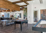 Thumbnail 38 of 54 - A pool table with a black cloth and red balls is in the center of a room with a wooden ceiling and a door marked "EXIT".