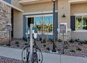 Thumbnail 52 of 54 - A bicycle is parked next to a charging station for electric vehicles.