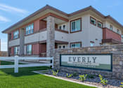 Thumbnail 53 of 54 - A modern house with a sign that reads "Everly" in front of it.