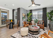 Thumbnail 7 of 54 - A living room with a round coffee table and a ceiling fan.