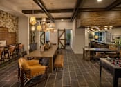 Thumbnail 64 of 69 - A room with a brick wall and a bar area.