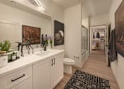 Thumbnail 16 of 69 - A bathroom with a sink, toilet, and a rug on the floor.
