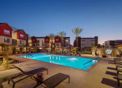 Thumbnail 1 of 76 - a swimming pool at night with apartments in the background at Weylyn Luxury Apartments, Arizona, 85339
