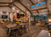 Thumbnail 11 of 76 - a dining room with a table and chairs and a kitchen with a large windowat Weylyn Luxury Apartments, Laveen, AZ