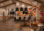 Thumbnail 8 of 76 - the lobby of a clubhouse with tables and chairs and a pool tableat Weylyn Luxury Apartments, Laveen, AZ