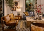 Thumbnail 14 of 76 - a living room with leather furniture and a large mirrorat Weylyn Luxury Apartments, Arizona, 85339