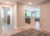 Thumbnail 25 of 52 - A modern kitchen with a dining area and a living room.