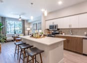 Thumbnail 6 of 52 - Dog-Friendly Luxury Apartments In North Phoenix, AZ - The Amelia - Gourmet Kitchen With Modern Cabinetry, Premium Quartz Countertops, Stainless Steel Appliances, And Tile Backsplash.