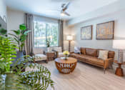 Thumbnail 12 of 52 - Luxury Apartments In North Phoenix, AZ With In-Unit Washer And Dryer - The Amelia - Living Area With Smart Home Technology, Open Concept Floor Plans, And Ceiling Fan.
