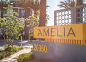 Thumbnail 52 of 52 - A sign for "The Amelia" is displayed in front of a building with palm trees.