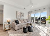 Thumbnail 18 of 26 - Modern living room with sliding glass door at Lucero Apartments, Phoenix, Arizona