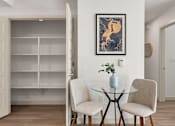 Thumbnail 22 of 26 - Dining area with glass table and builtin shelving at Lucero Apartments, Phoenix