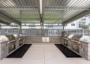 Thumbnail 8 of 26 - Outdoor grilling stations with covered pavilion at Lucero Apartments, Phoenix, AZ