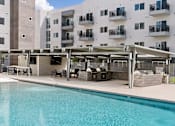 Thumbnail 5 of 26 - Resort style pool with covered barbecue area at Lucero Apartments, Phoenix