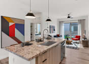 Thumbnail 14 of 35 - A modern kitchen with a granite countertop and a large abstract painting above it.at Marketside Villas at Verrado, Buckeye, AZ, 85396