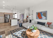 Thumbnail 15 of 35 - A modern living room with a white sofa, a wooden coffee table, and a large abstract painting on the wall.at Marketside Villas at Verrado, Buckeye, 85396
