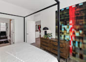 Thumbnail 18 of 35 - A bedroom with a large bed and a dresser.at Marketside Villas at Verrado, Arizona, 85396