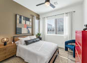Thumbnail 22 of 35 - A bedroom with a bed, a chair, and a painting on the wall.at Marketside Villas at Verrado, Arizona, 85396