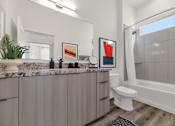 Thumbnail 23 of 35 - A bathroom with a marble countertop and a white toilet.at Marketside Villas at Verrado, Buckeye, AZ