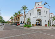 Thumbnail 32 of 35 - A white building with a red sign that says at Marketside Villas at Verrado, Buckeye, AZ, 85396