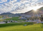 Thumbnail 33 of 35 - A golf course with a green lawn and a mountain in the background.at Marketside Villas at Verrado, Buckeye Arizona