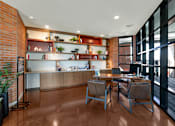 Thumbnail 6 of 35 - A modern office space with a wooden floor and a brick wall.at Marketside Villas at Verrado, Buckeye, AZ