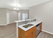 Thumbnail 10 of 37 - a kitchen with a stainless steel sink and a counter top