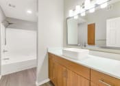 Thumbnail 16 of 37 - a bathroom with a sink and a mirror