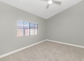 Thumbnail 21 of 37 - an empty room with a window and a ceiling fan