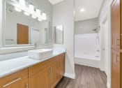 Thumbnail 22 of 37 - a bathroom with a sink and a mirror