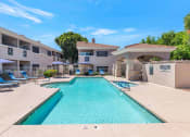 Thumbnail 2 of 37 - a swimming pool with a building in the background