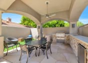 Thumbnail 30 of 37 - the patio has a grill and a table with chairs