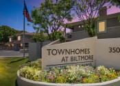 Thumbnail 31 of 37 - a sign for the townhomes at biltmore in front of a flag