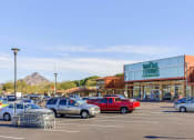 Thumbnail 36 of 37 - a parking lot filled with cars in front of a shopping center
