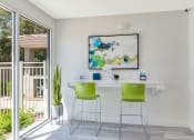 Thumbnail 4 of 37 - a home office with green chairs and a white desk and a painting on the wall