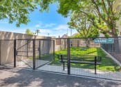 Thumbnail 7 of 37 - a gate to a park with a bench and a fence