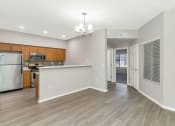 Thumbnail 8 of 37 - an empty kitchen and living room with a refrigerator and a sink