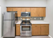 Thumbnail 9 of 37 - a kitchen with stainless steel appliances and wooden cabinets