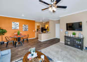 Thumbnail 14 of 36 - A living room with a dining table and chairs at Montage at Pecos Ranch Apartments, Chandler