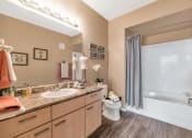 Thumbnail 19 of 36 - A bathroom with a sink, toilet, and bathtub at Montage at Pecos Ranch Apartments, Chandler, AZ, 85286