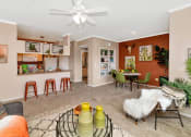 Thumbnail 24 of 36 - A living room with a couch, chairs, and a coffee table at Montage at Pecos Ranch Apartments, Arizona