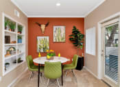 Thumbnail 25 of 36 - a dining room with a table and chairs      and a window at Montage at Pecos Ranch Apartments, Arizona, 85286